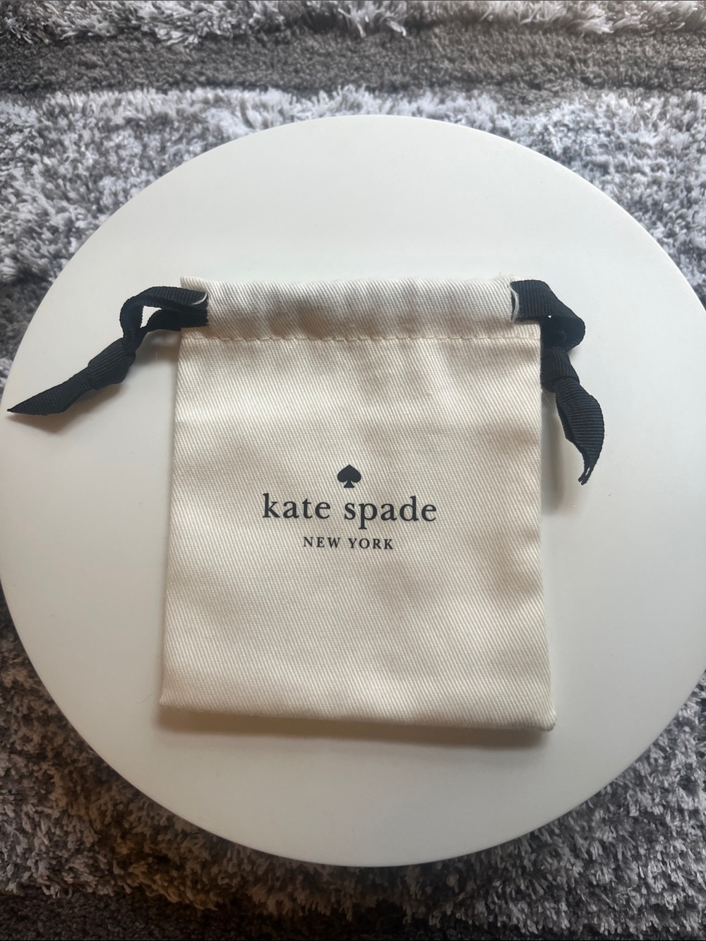 kate spade Cream Drawstring Jewelry Pouch with Black Ribbon